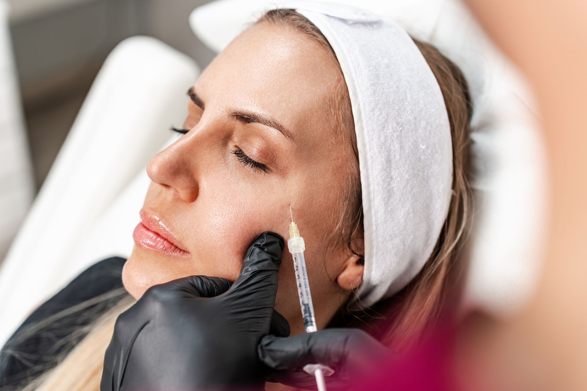 Person receiving facial injection.