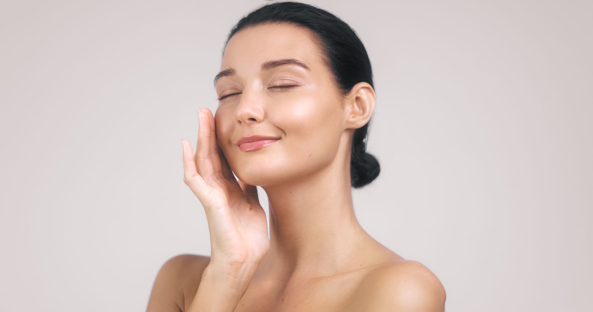 Woman with curly brown hair smiling.