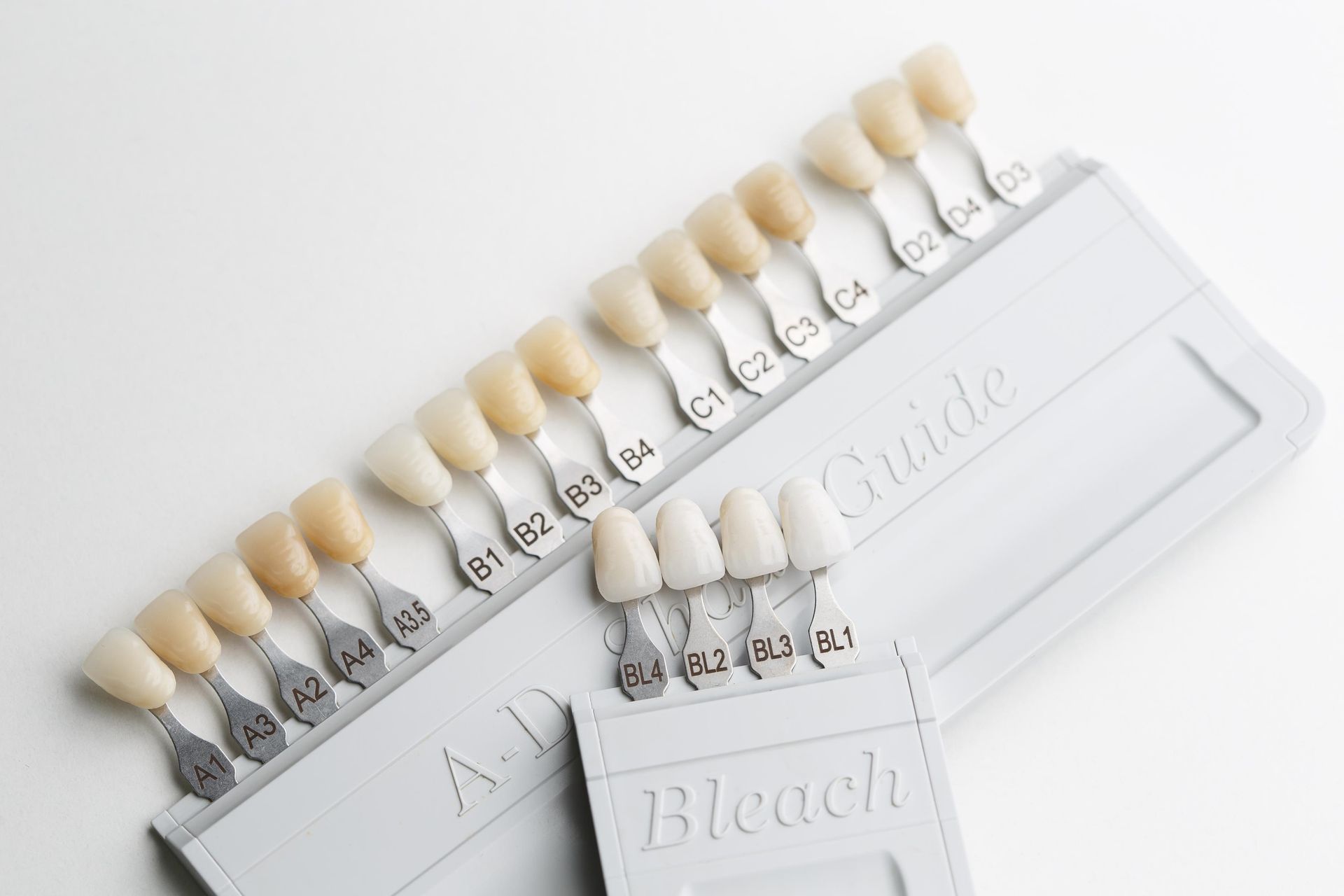 Teeth shade guide with rows of artificial tooth samples on white cards