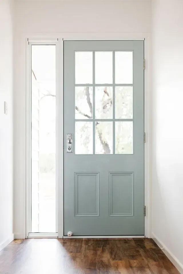 Light Blue Front Door With Glass Panels and Sidelight, Set in a White Hallway With Wood Flooring — George Pappas Painting In Buderim, QLD