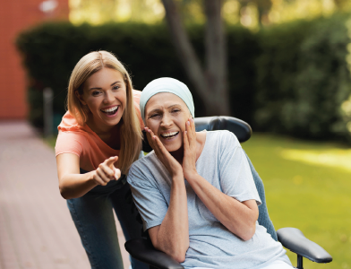A nurse is holding the hand of an elderly woman
