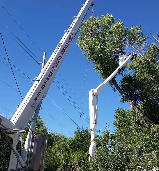 A white crane with the word crane service on it. A white crane with the word crane service on it.