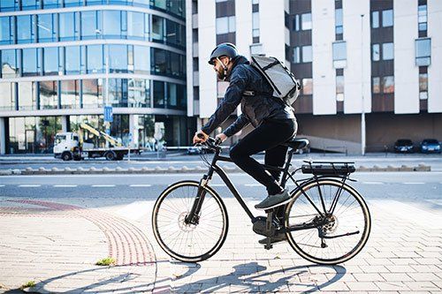 Man Riding A Bicycle In City