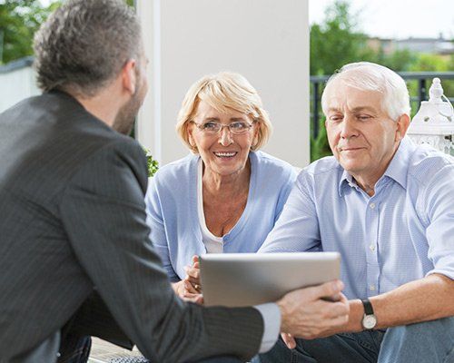 senior couple discussing with a lawyer.