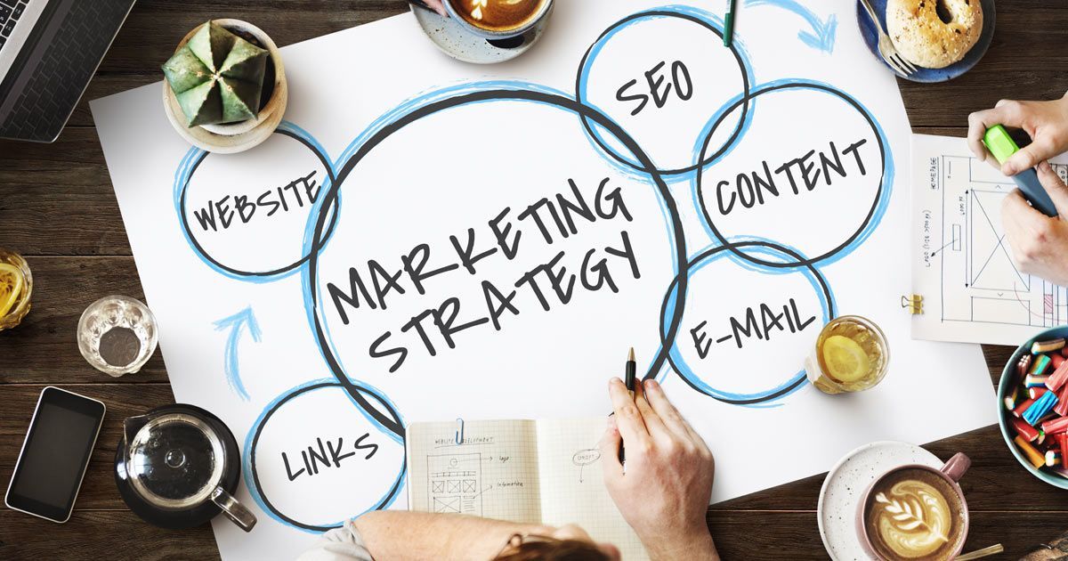 Content Marketing Company - Solution Web Designs Marketing strategy brainstorm with website, SEO, content, and email elements on paper.