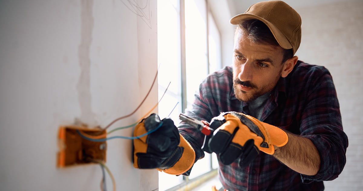 Electrician doing work for his new client after building Websites for Electricians by Solution Web Designs