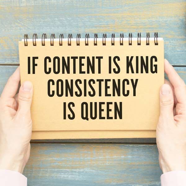 Consistent Publishing and Long-Term Support, Hands holding a notebook with the text 