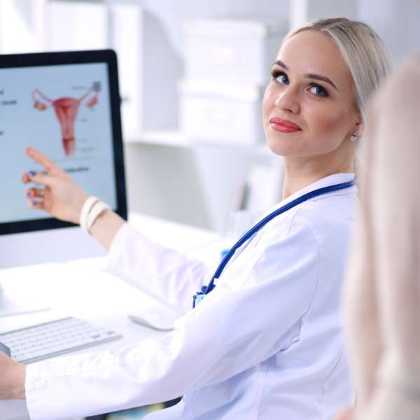 A female functional Medicine Doctor is showing her patient a chart referring to her diagnosis.