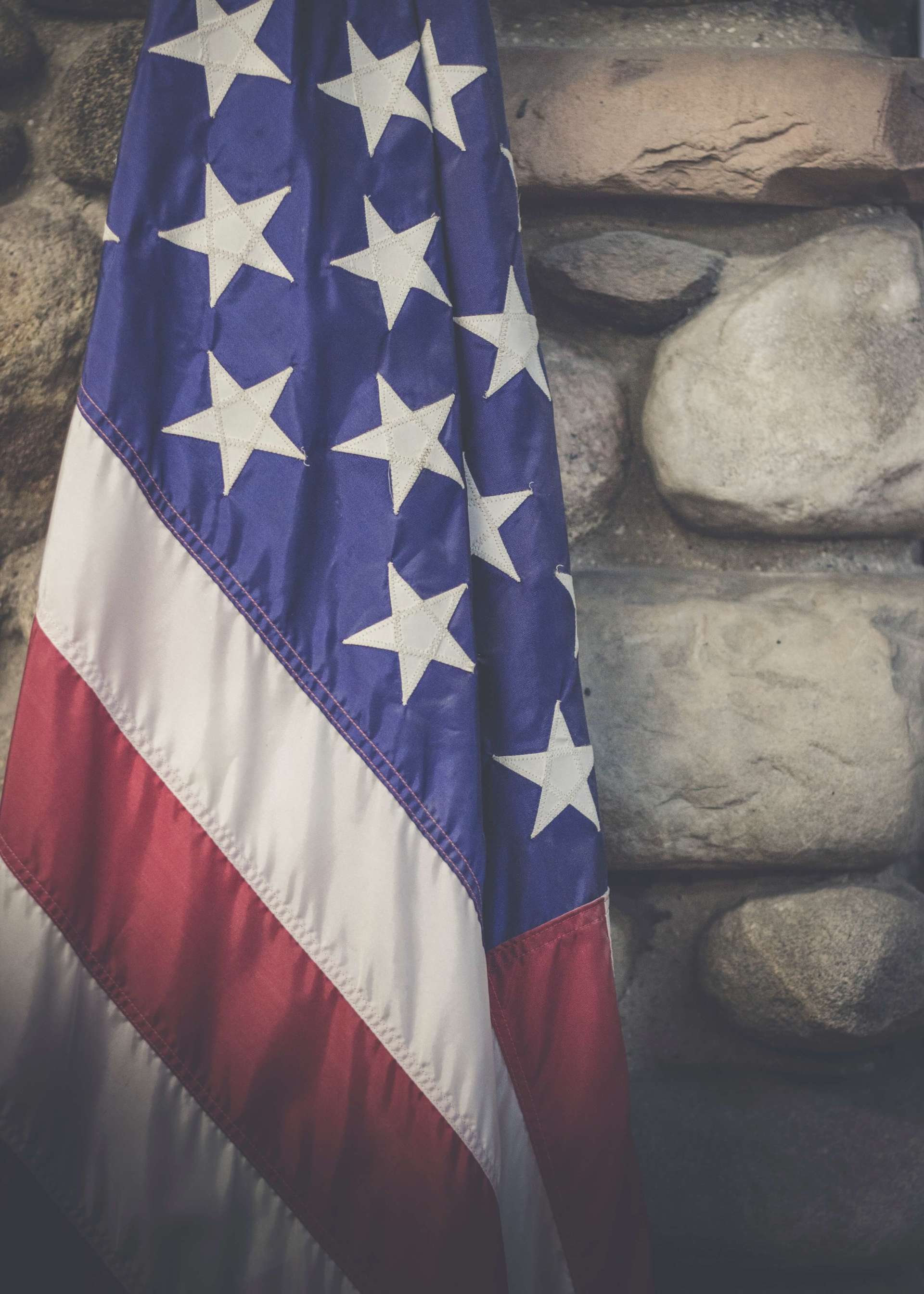 veteran funeral services american flag brick wall