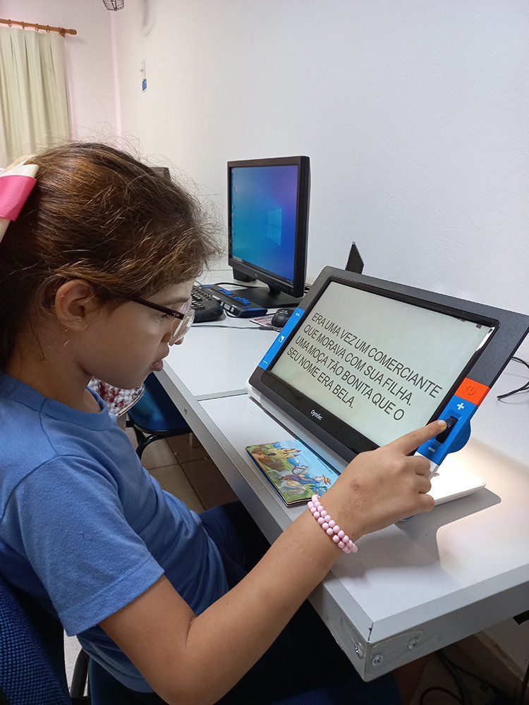 Menina utilizando monitor de leitura.