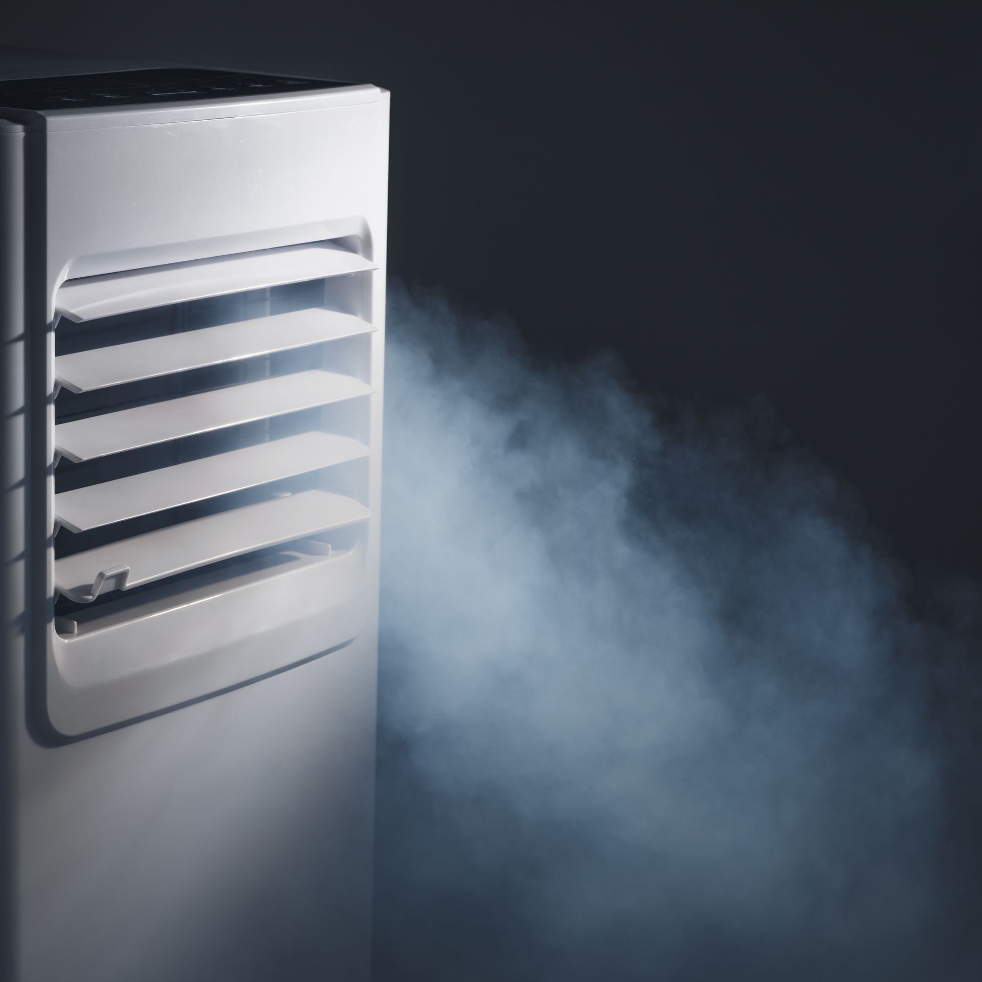 A white air conditioner with smoke coming out of it