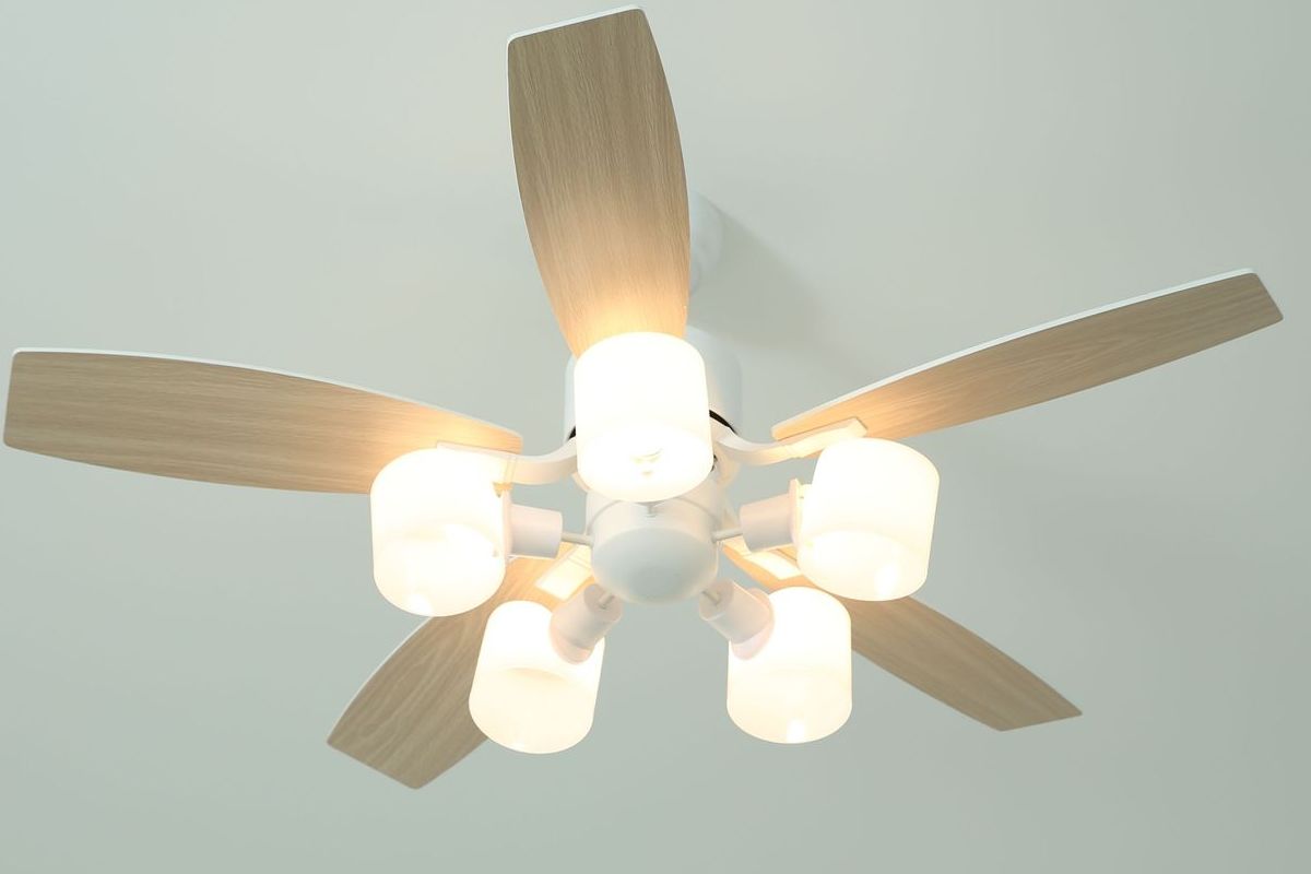 A ceiling fan is hanging from the ceiling in a room