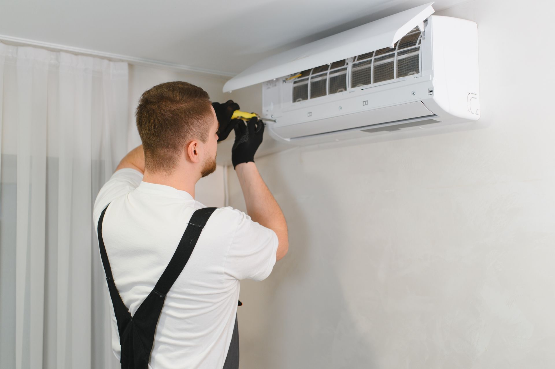 C&G Heating and Air technician installing ac in Auburn, AL