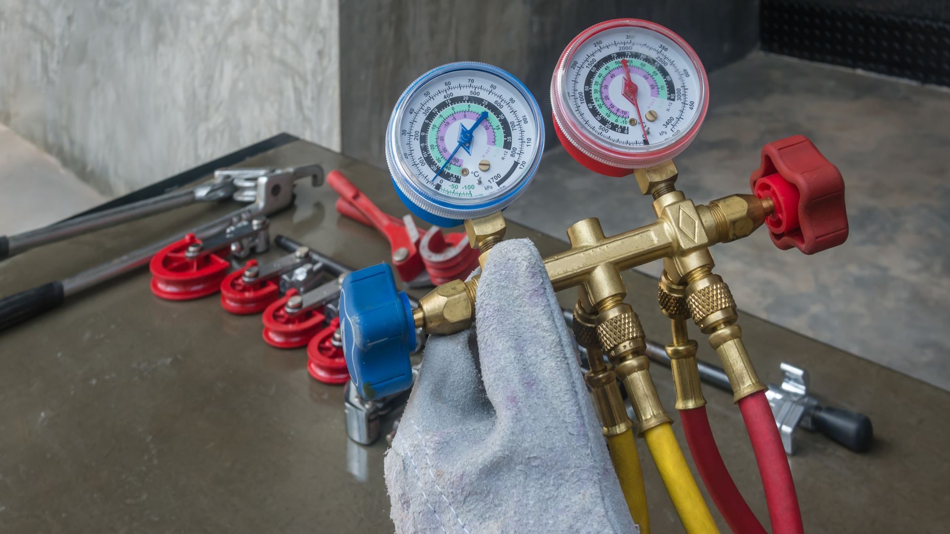 A person is holding a pressure gauge in their hand.