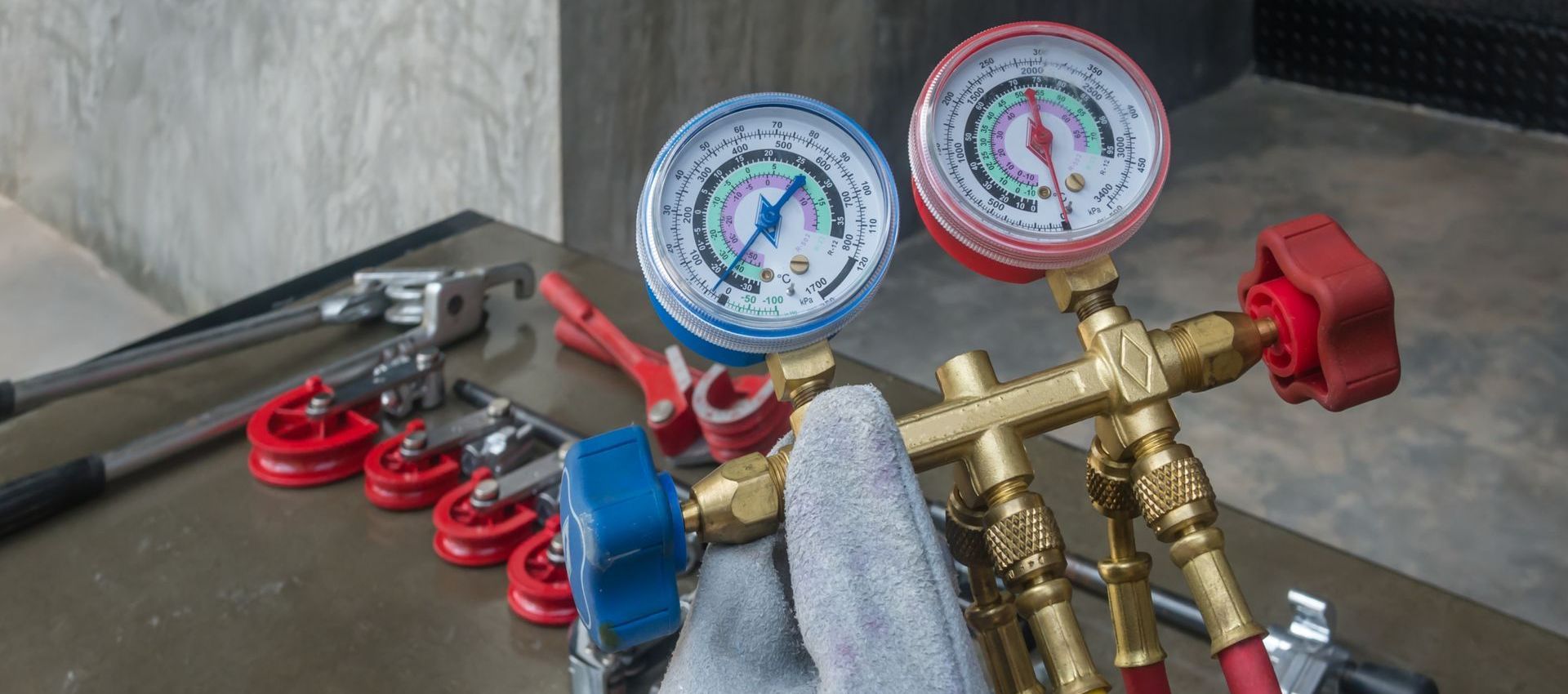 A person is holding a pressure gauge in their hand.