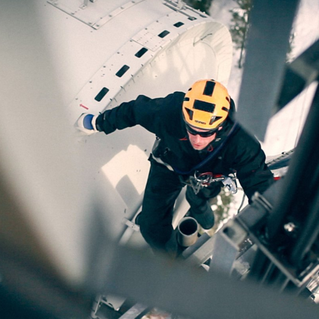 Overhead view of a working climbing up  an antenna with climbing gear. 