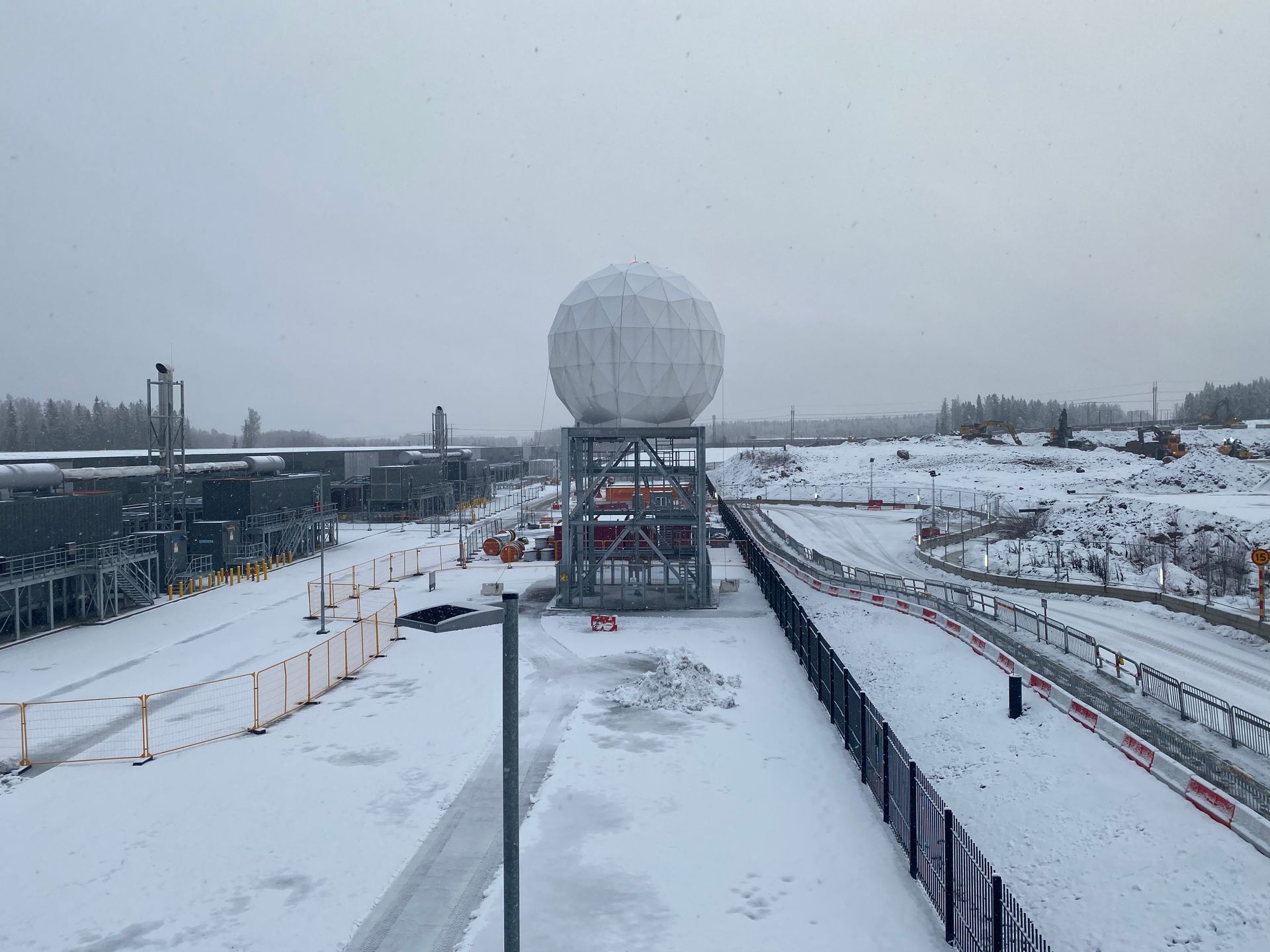 Antenna with a covering dome in the middle of a snowy landscape