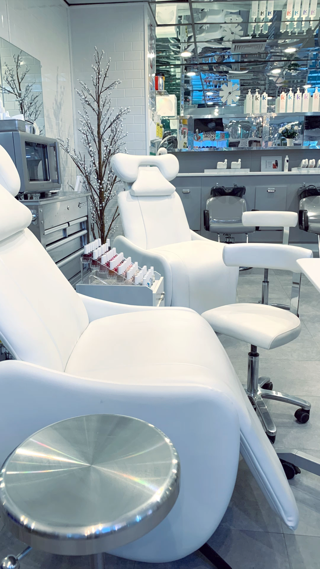 A row of white chairs in a beauty salon.