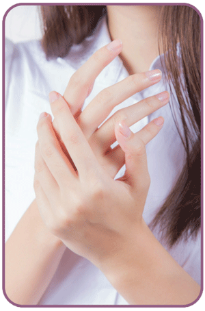 A woman in a white shirt is holding her hands together showing her nice nails