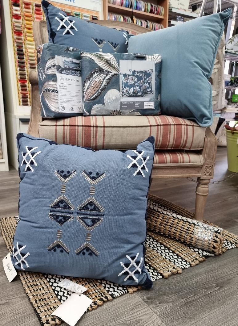 A Chair With Blue Pillows Sitting on Top of It — Atherton Decor Centre In Atherton, QLD
