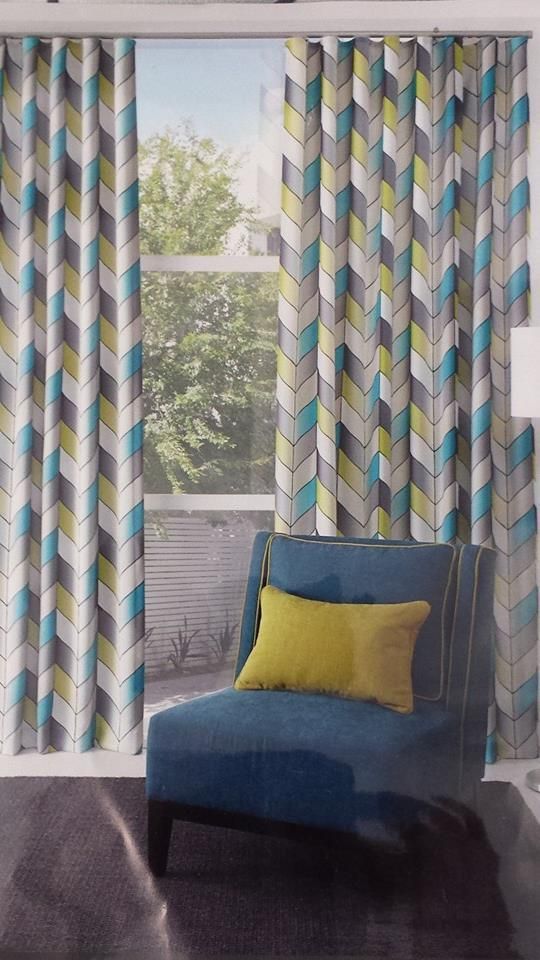 A Living Room With a Blue Chair and a Yellow Pillow — Atherton Decor Centre In Atherton, QLD