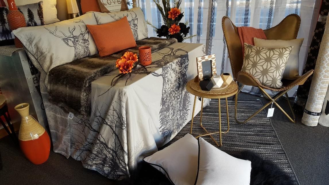 A Living Room With a Bed , Chair , Table and Vases — Atherton Decor Centre In Atherton, QLD