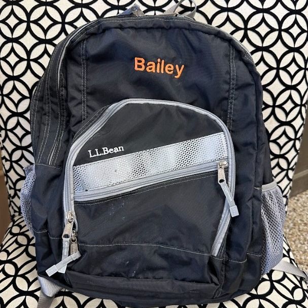A black backpack with bailey embroidered on it.