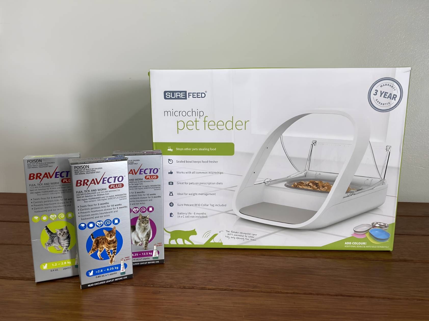 A Cat Feeder Is Sitting On A Wooden Table — Valley Vet Surgery In Walkerston, QLD