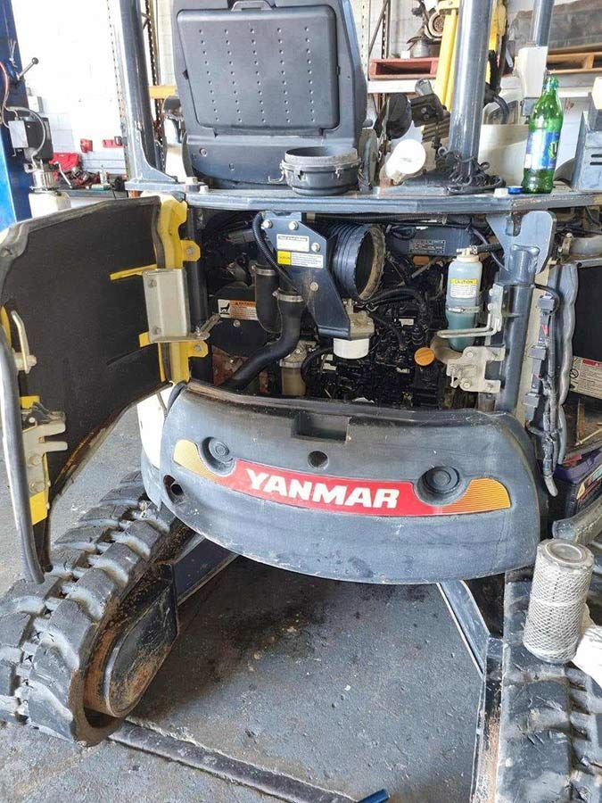 A Yanmar Mini Excavator is Sitting in a Garage With Its Hood Open — OG Diesel NQ in Garbutt, QLD