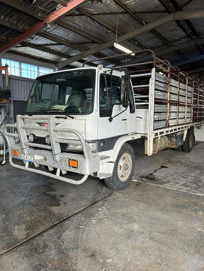 A White Truck With a Fence on the Back is Parked in a Garage — OG Diesel NQ in Garbutt, QLD