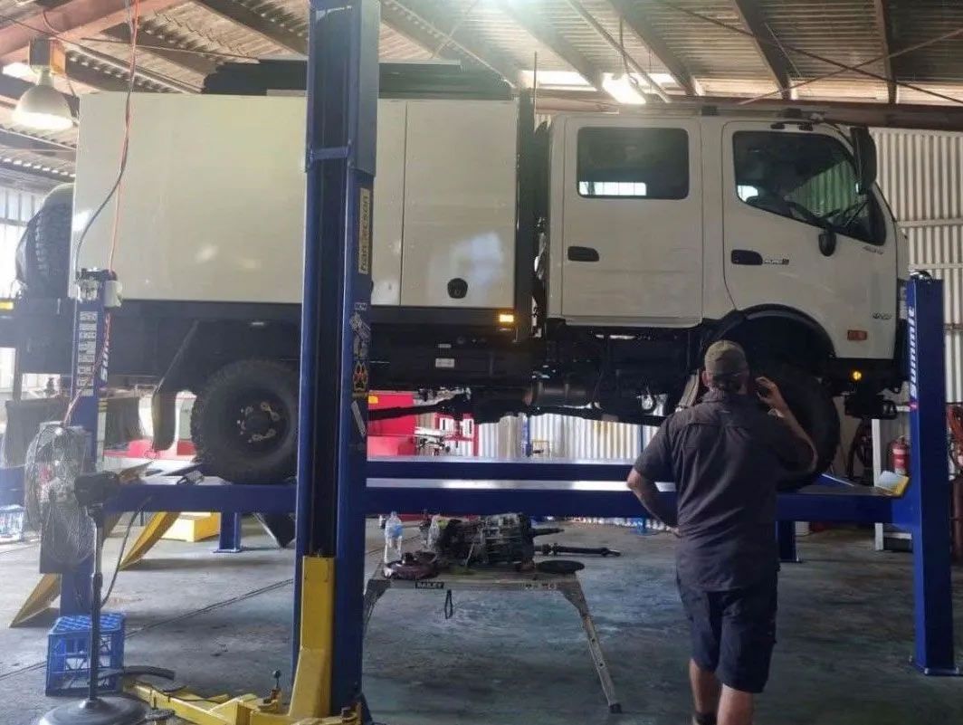 A White Truck is on a Lift in a Garage — OG Diesel NQ in Garbutt, QLD