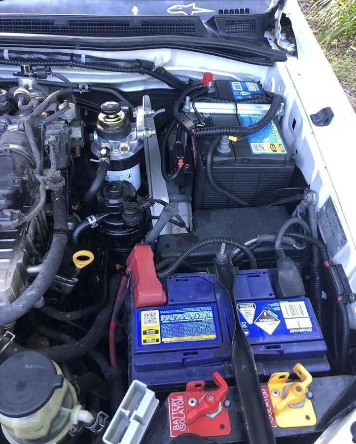 The Engine of a White Car With Two Batteries in It — OG Diesel NQ in Garbutt, QLD
