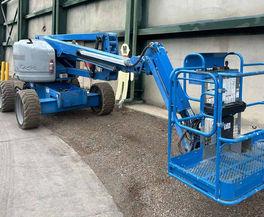 A Blue Lift With a Basket Attached to It is Parked in Front of a Building — OG Diesel NQ in Garbutt, QLD