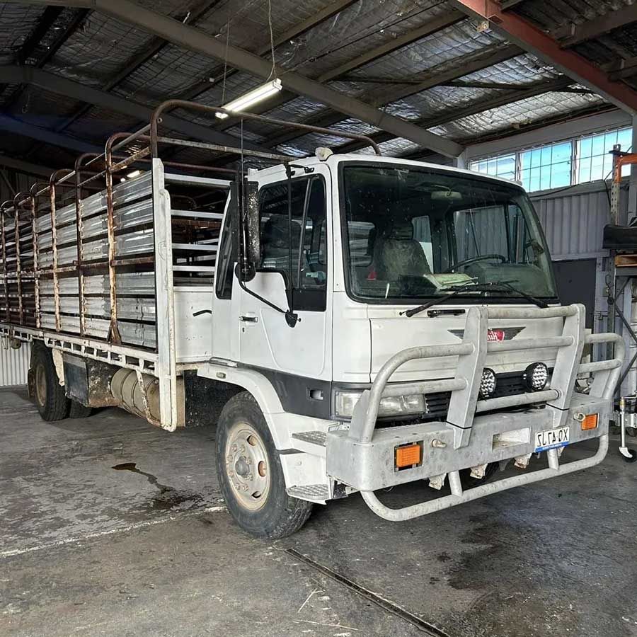 A White Truck With a Fence on the Back is Parked in a Garage — OG Diesel NQ in Garbutt, QLD