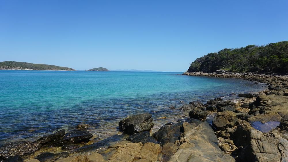 A Rocky Shoreline With a Large Body of Water in the Background — Bonanno's Menswear in Kiama, NSW