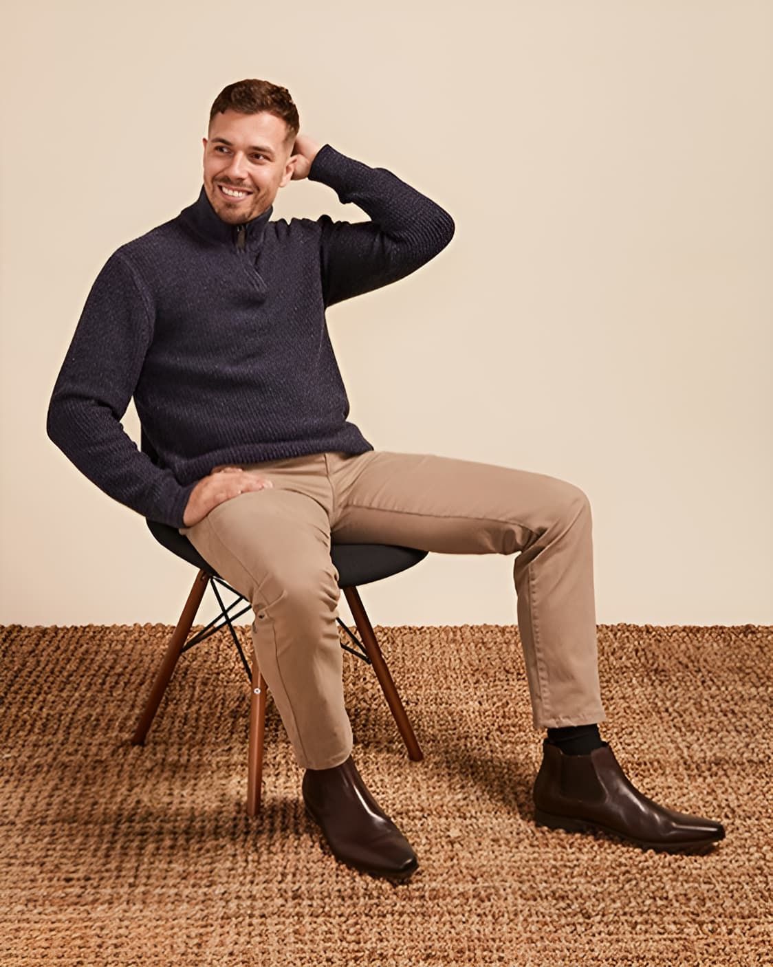 A Man is Sitting in a Chair Wearing a Blue Sweater and Khaki Pants — Bonanno's Menswear in Engadine, NSW