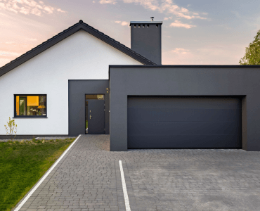 A white and black house with a black garage door