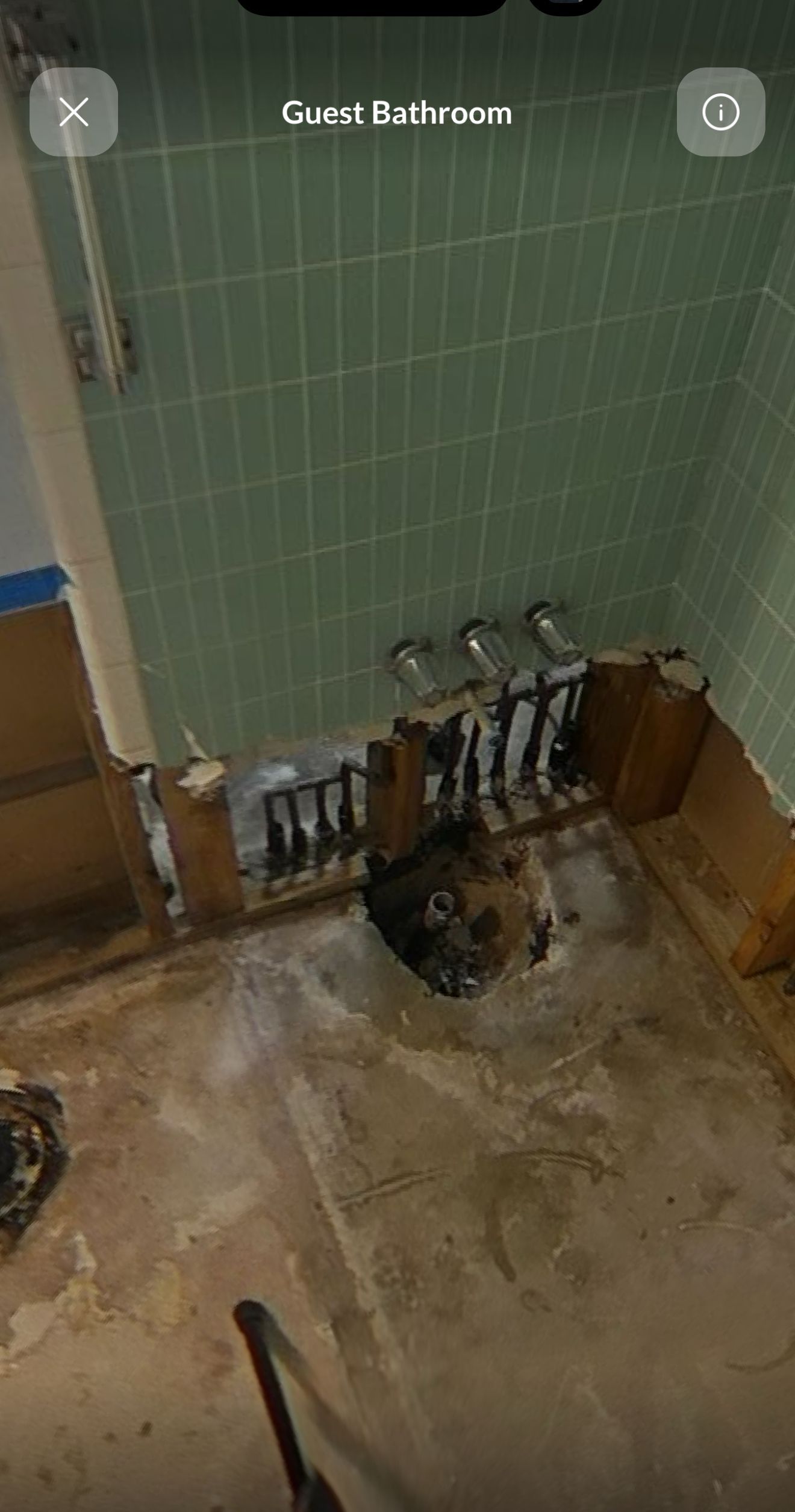 A picture of a bathroom with a hole in the floor.