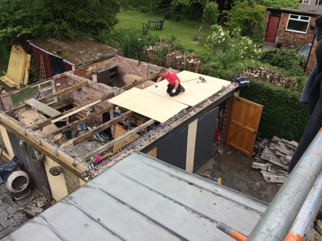 a picture of one of our roofers in Manchester working on a flat roof replacement