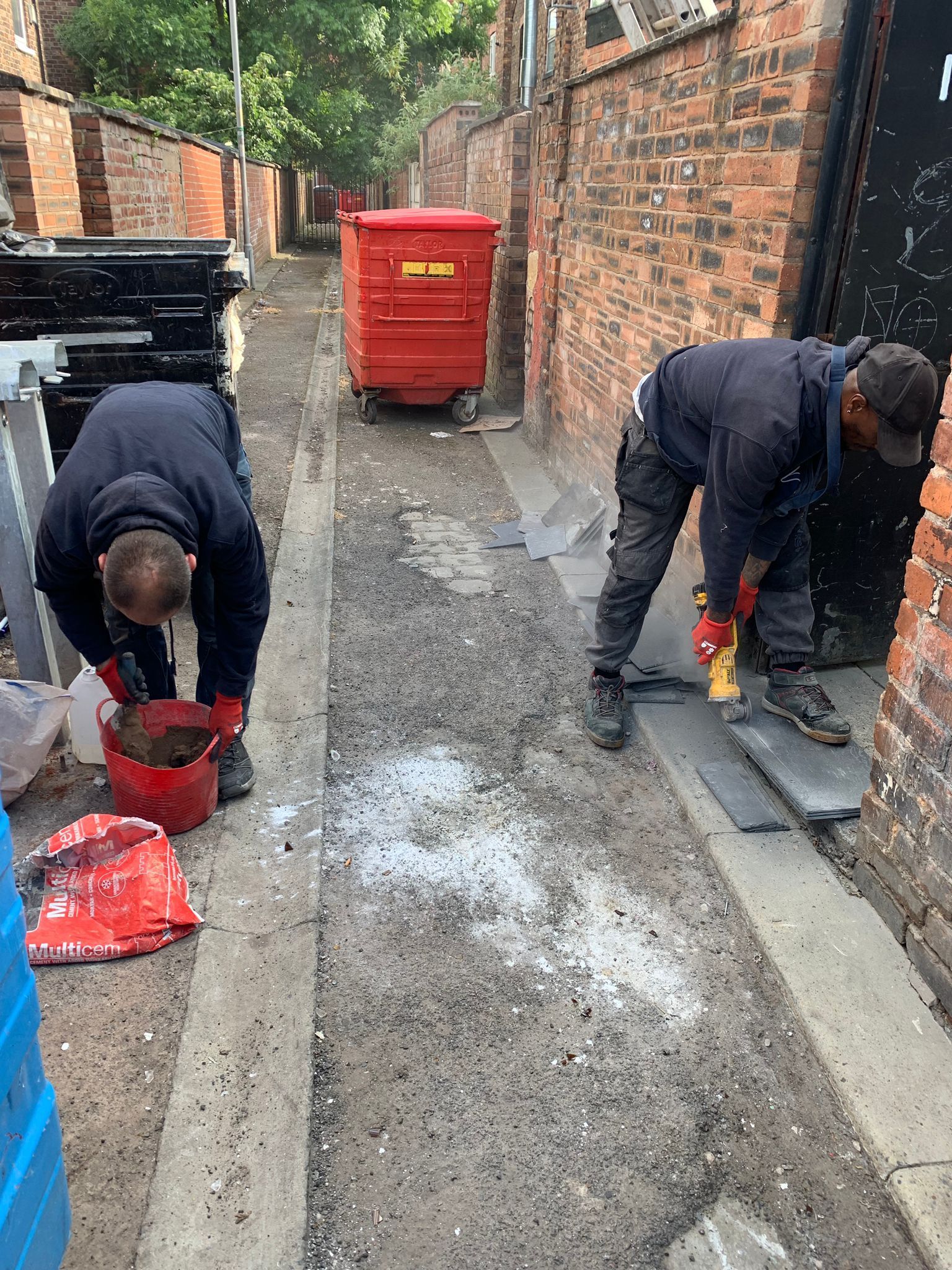 a picture of the Manchester roofing team mixing mortar