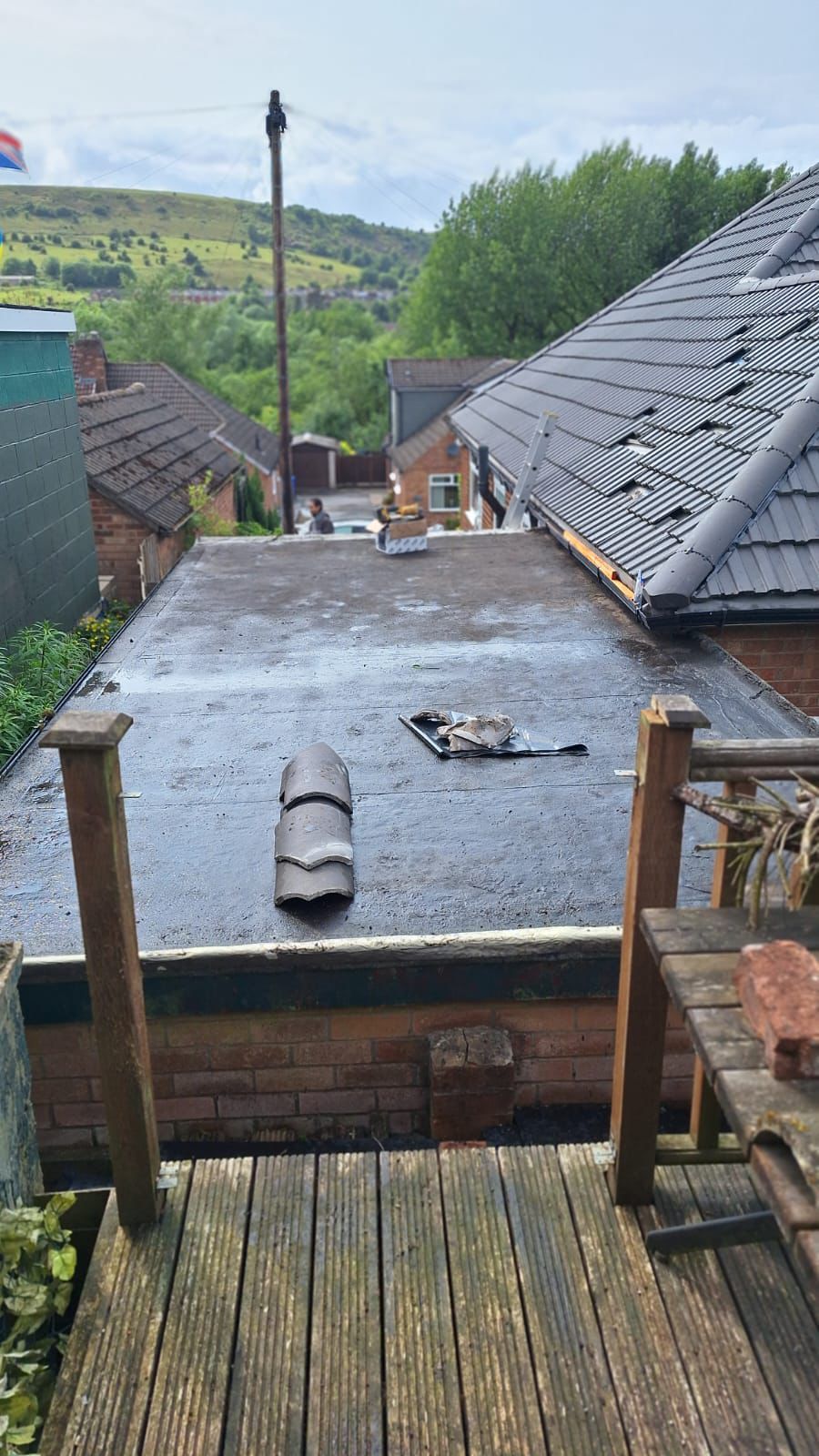 A view of a roof from a wooden deck.