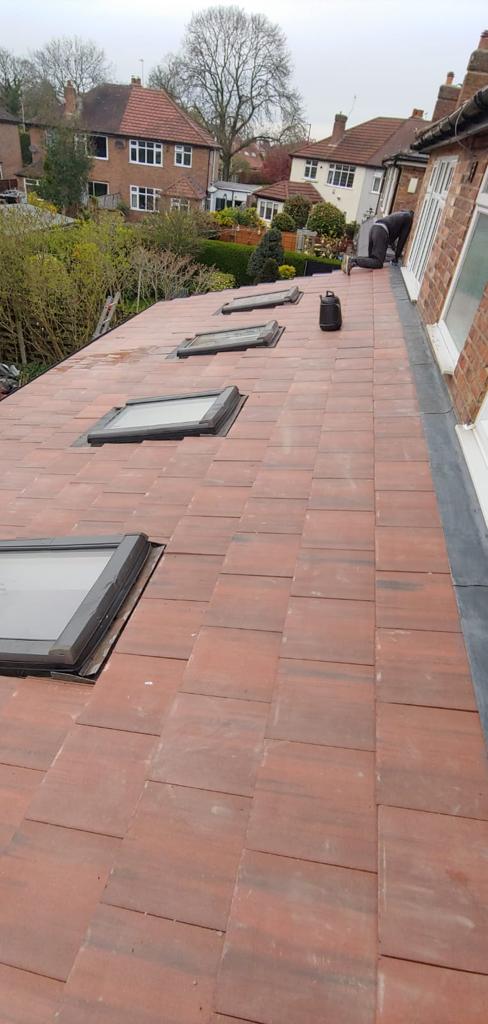 Picture of an extension roof in red duo clay tiles with three new skylights installed by Roofers Manchester