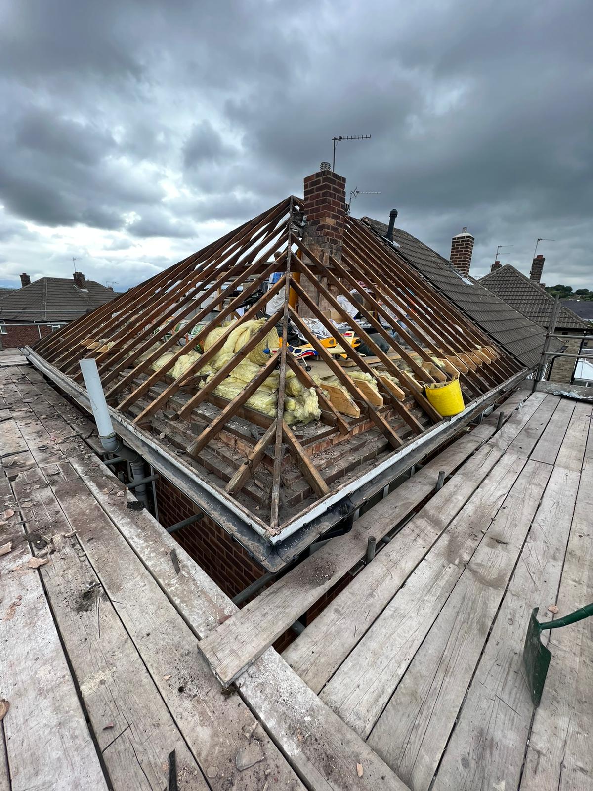 A picture of a hipped roof that has been stripped by Roofers Manchester