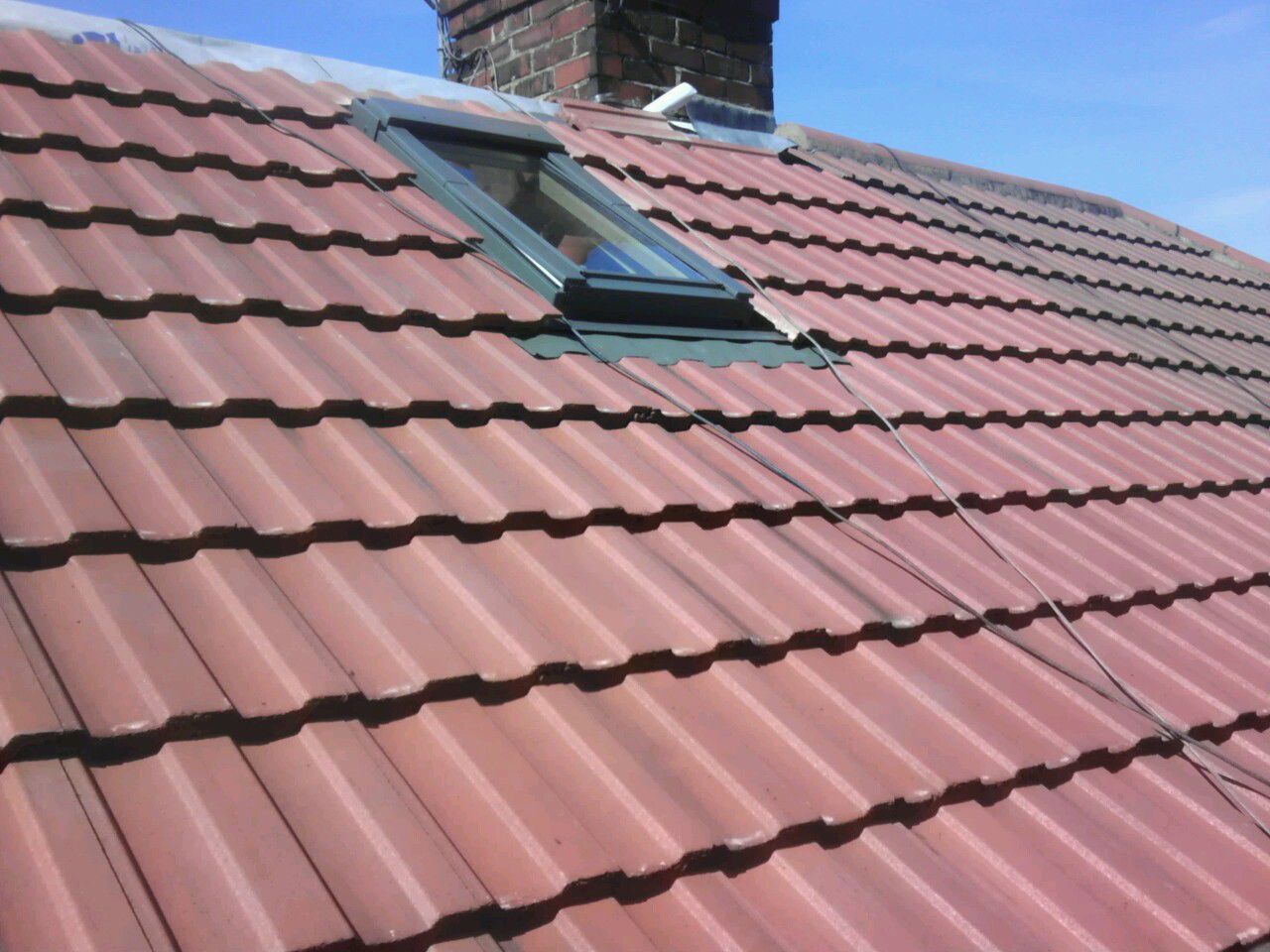 A roof with a skylight in the middle of it