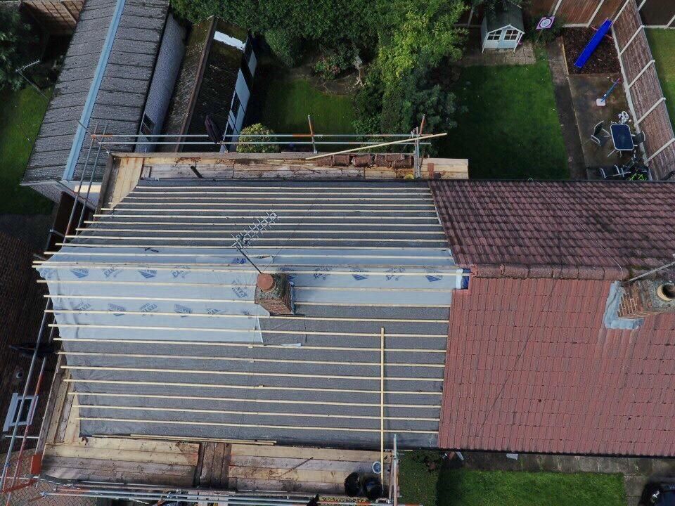 An aerial photograph of a pitched roof being replaced in Manchester