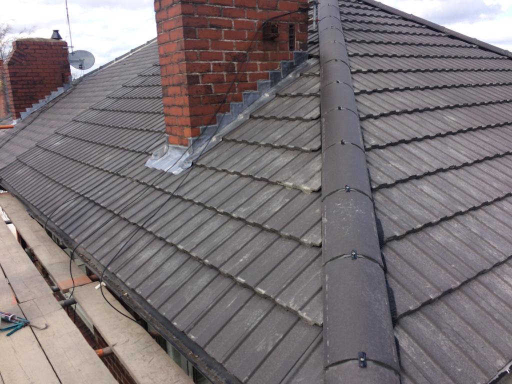 A picture of a new hipped roof with concrete profile tile by roofers Manchester