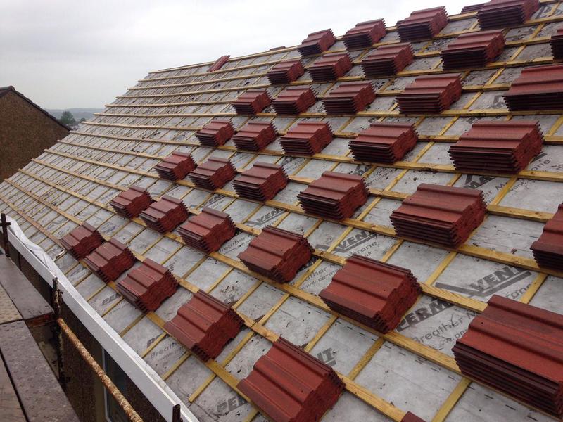 A picture of roof tiles stacked on a roof that is being replaced