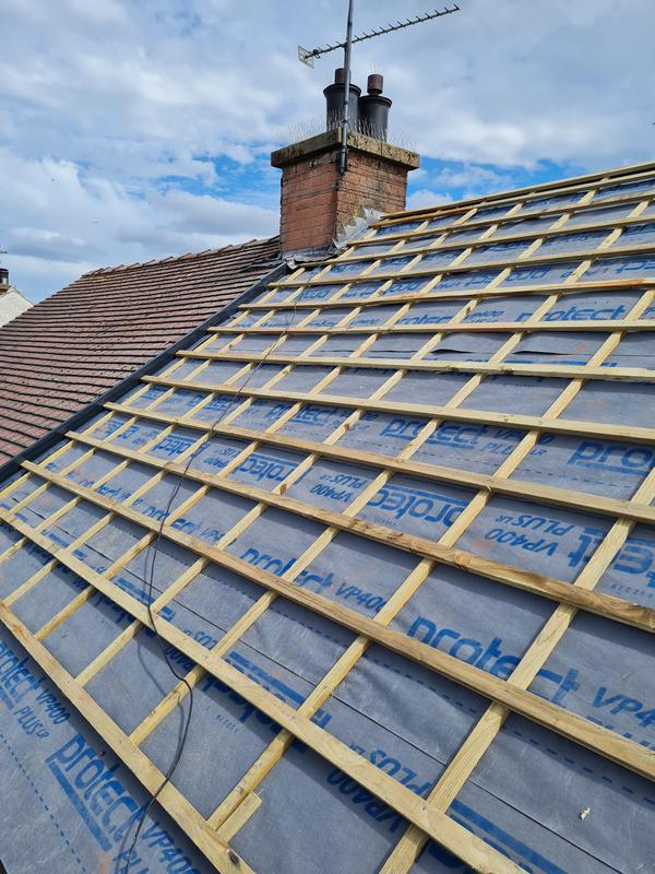 A picture of roof replacement being carried out by roofers Manchester