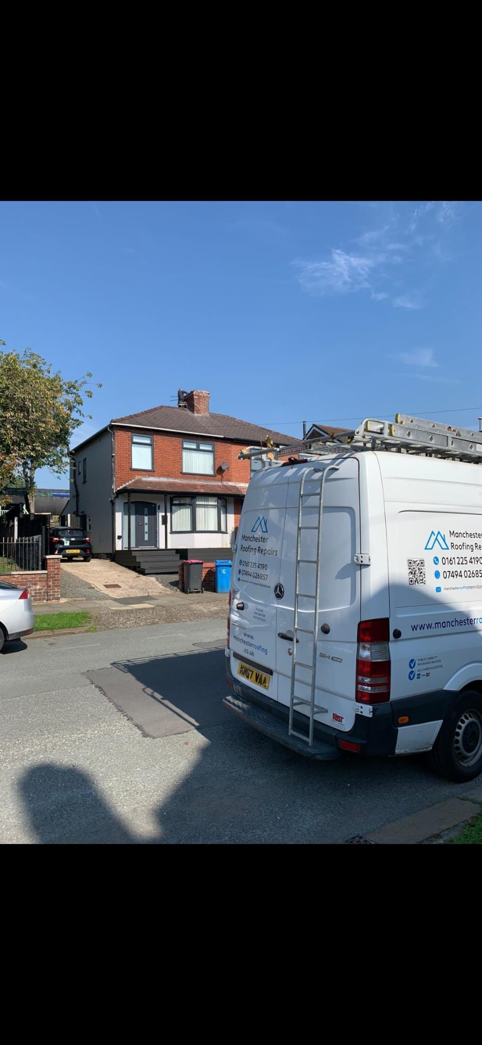 A white van is parked in front of a house.