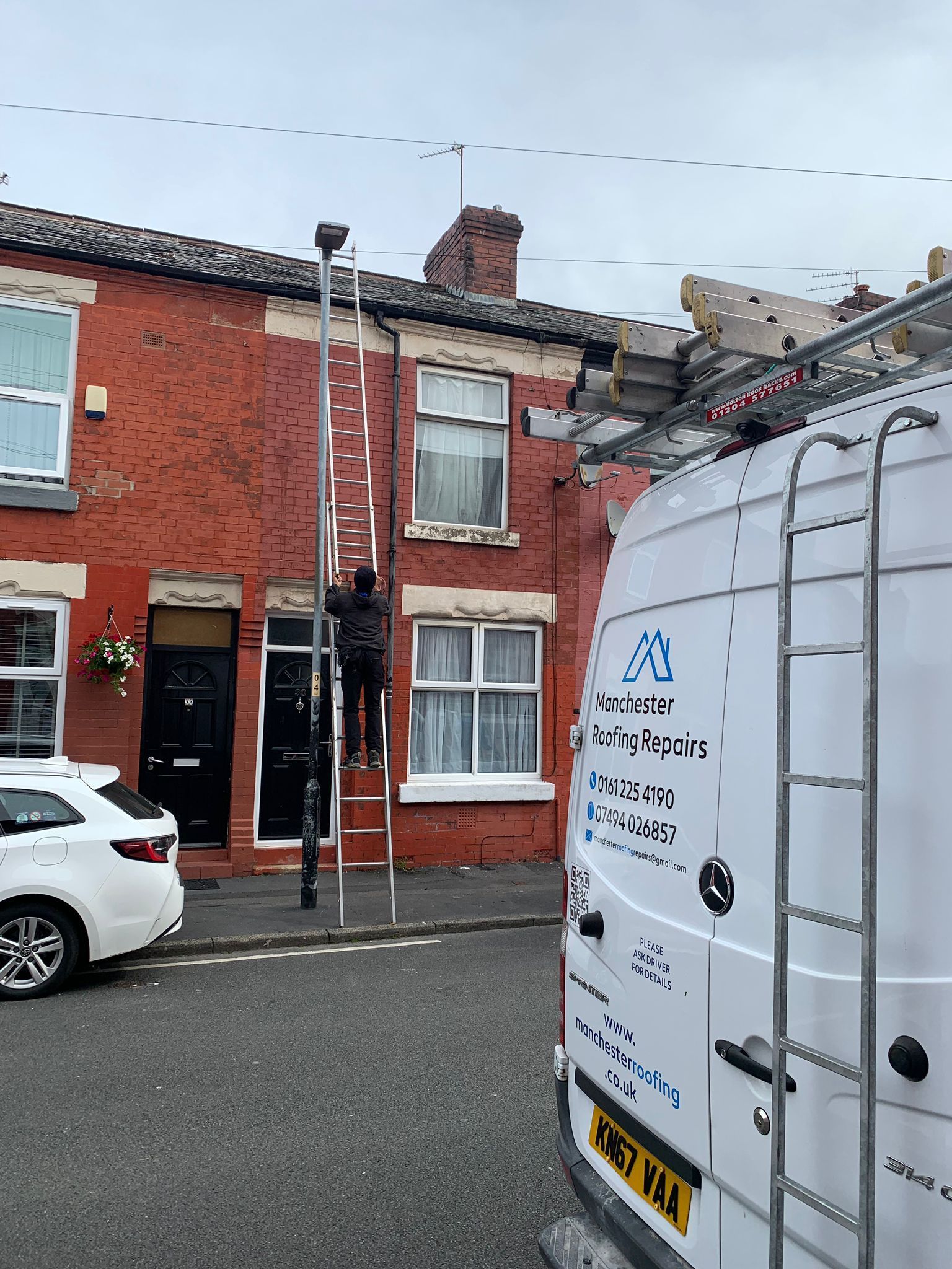 a picture of the Manchester roofing team working on a terraced property roof